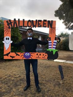 a man in a halloween costume holding up a sign