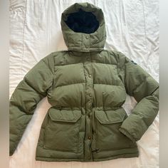 A Sage Green 550 Down North Face Jacket, Originally Purchased In Australia! Features A Removable Hood, Two Pairs Of Pockets (One Closable With Zippers/One Closable With Velcro), A Two Way Zipper, Elastic Wrist Cuffs, And An Adjustable Waist. This Jacket Will Keep You Warm Effortlessly, And Will Look Stylish To Boot! Women’s Medium I Am Usually A Women’s Small In Jackets, And This Jacket Is A Little Tight Through The Shoulders On Me! So Keep This In Mind When Considering Layering! The Jacket Is Down Though, So It Will Keep You Warm Without Layers Anyways. Gently Used Women’s Down Jacket Women’s Winter Jacket Down Jacket Green Sage Green Adjustable Waist Zipper Pockets Removable Hood The North Face Winter Outerwear With Pockets, Green Winter Parka For Workwear, Green Winter Workwear Parka, The North Face Cold Weather Puffer Outerwear, The North Face Puffer Outerwear For Cold Weather, The North Face Puffer For Cold Weather, The North Face Fall Puffer Jacket With Pockets, The North Face Puffer Jacket With Pockets For Fall, Olive Utility Winter Outerwear