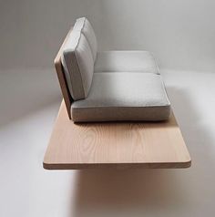 a couch sitting on top of a wooden table