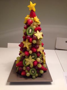 a small christmas tree made out of fruit