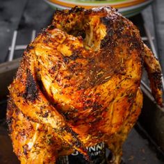 a whole chicken sitting on top of a grill