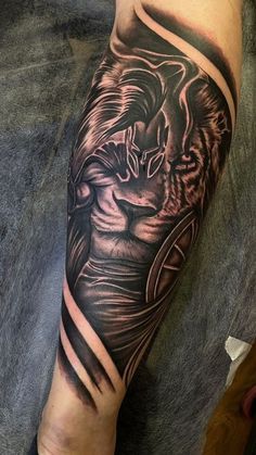 a man's arm with a lion tattoo on it