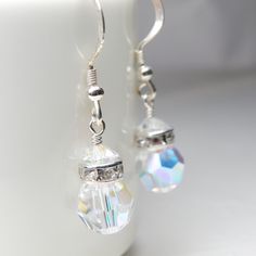 Drop crystal earrings are handmade with crystal clear faceted round crystal balls. Accented with a sparkly rhinestone crowns and offered on sterling silver or gold filled earring closures. Earrings are handmade with genuine Swarovski crystals - re-known for their fire and diamond like sparkle. A thoughtful gift for women born in April since diamond is her birthstone, or October since opal is hers.  Practical and wearable with everything in your closet. A great gift for your bridesmaids as a than Clear Crystal Dangle Earrings, Clear Crystal Pierced Earrings, White Round Crystal Earrings, Faceted Crystal Party Earrings, Sparkling Crystal Drop Earrings, Faceted Crystal Teardrop Earrings, Sparkling Drop Crystal Earrings, Faceted Crystal Dangle Earrings For Weddings, Faceted Crystal Dangle Earrings