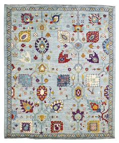 a blue rug with many different colors and designs on the front, in various sizes