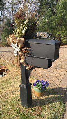 a mailbox decorated with flowers and ribbons