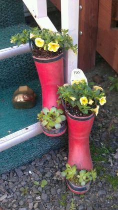 two red flower pots sitting on the steps