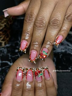 two hands with pink and leopard print nail designs