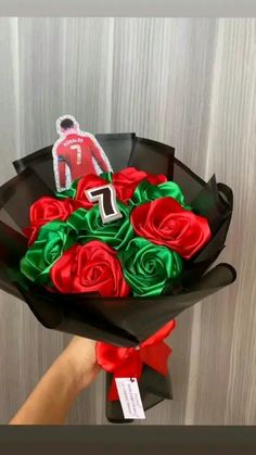 a person holding a bouquet of red roses with a sticker on the top that says f