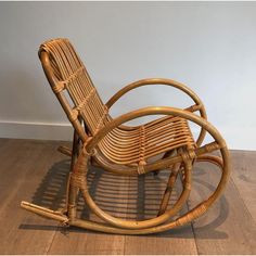 a wooden rocking chair sitting on top of a hard wood floor