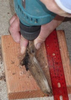 a person using a drill to cut wood