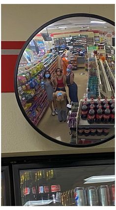 a mirror reflecting people in a grocery store