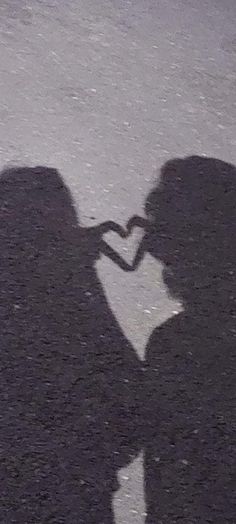 the shadow of a man and woman kissing