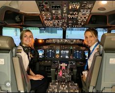 two women sitting in the cockpit of an airplane