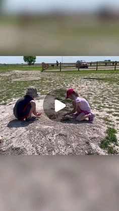 two children are playing in the sand on a sunny day