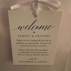 a welcome sign hanging on the wall with a ribbon around it's edge that says, welcome family & friends