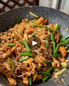 a wok filled with stir fry vegetables and meat