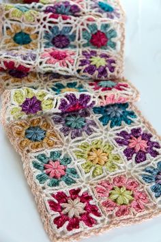 two crocheted squares with flowers on them