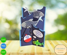 an open card with fish on it sitting on a table