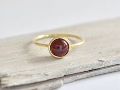 Gold ring with natural garnet. Made of 585/14k solid gold (yellow, rose or white - your choice). Width 1.2 mm, diameter of central part is 8 mm. Model's ring size on photo is 7US. Gold Garnet Rings With Cabochon, Yellow Gold Cabochon Birthstone Ring Gift, Yellow Gold Birthstone Ring With Cabochon For Gift, 14k Gold Cabochon Birthstone Ring Gift, Gold Garnet Ring, Garnet Gem, Carnelian Ring, Etsy Gold Ring, Red Band