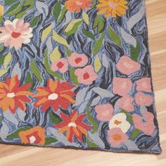 a rug with flowers on it sitting on the floor