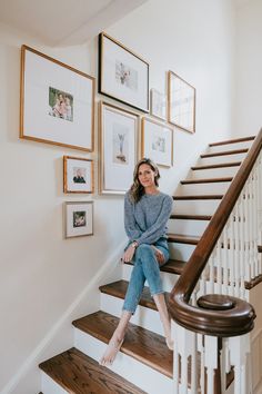 a woman sitting on the stairs in her home