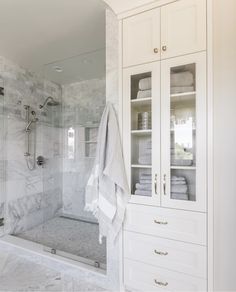 a bathroom with white cabinets and marble flooring is featured on the instagram page