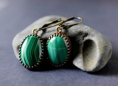 "Malachite Earrings - Cabochon Emerald Green Earrings - Antique Gold Bezel - Gemstone Jewelry - Personalized Gift .. .. .. Gorgeous artisan handcrafted natural stone malachite earrings feature brilliantly polished cabochon malachite gemstones. Rich lush forest green, emerald, and light green hues display unique striped patterns. Each stone is extremely beautiful high quality Grade B. I carefully hand set each gemstone in high quality open back crown trim edged styled antiqued gold brass plated b Elegant Green Agate Earrings, Elegant Green Onyx Earrings For Gift, Green Onyx Jewelry With Matching Earrings, Green Agate Gemstone Earrings, Green Onyx Drop Earrings For Gifts, Green Malachite Bohemian Jewelry, Formal Oval Malachite Jewelry, Formal Green Malachite Jewelry, Green Brass Drop Earrings