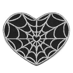 a heart shaped spider web patch on a white background