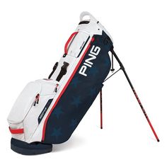 a white and grey golf bag sitting on top of a stand