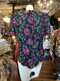 "This is a vintage beaded and sequinned silk top from the 1980's or 1990's. The label is from Stenay, marked size large. It features a vivid floral pattern in pink, teal, green and gold beads and sequins. This top open down the back with a well working zipper. This top is in excellent condition. Lined, with removable shoulder pads. Comes from a smoke free home. Measurements: Bust: 40\" Waist: 34\" Hip: 42\" Across Shoulder: 16.5\" Sleeve Length: 9\" Length from Shoulder: 27\" Please ask me any q Vintage Embroidered Party Blouse, Vintage Embroidered Blouse For Party, Vintage Embroidered Party Tops, Vintage Embroidered Tops For Parties, Vintage Beaded Tops For Party, Multicolor Silk Tops For Evening, Vintage Multicolor Tops For Party, Embellished Multicolor Party Blouse, Embellished Multicolor Blouse For Party