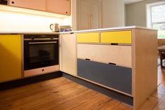 a kitchen with an oven, microwave and table in the middle of it's counter space