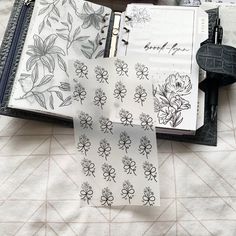 an open planner book sitting on top of a bed