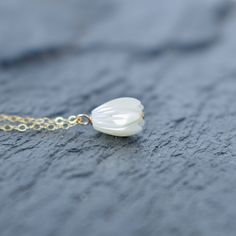 Beautiful hand carved Mother of Pearl Pikake bead necklace. These Pikake are not plastic, they are real carved mother of pearl. This Pikake necklace is so dainty and pretty to look at! Check out the matching earrings here: https://www.etsy.com/listing/1028920579/single-pikake-mother-of-pearl-earring Your choice of sterling silver or gold fill - they will not tarnish and can even get wet. Each Pikake is hand carved and may vary slightly one from the next in size and details. White Pearl Necklace With Flower Pendant As A Gift, White Dainty Shell Necklace As A Gift, Dainty White Shell Necklace For Gift, White Pearl Necklace With Flower Pendant Gift, Dainty White Shell Necklace For Gifting, Handmade Flower Shell Necklace Gift, Handmade Mother Of Pearl Flower Necklace, Mother Of Pearl Shell-shaped Necklace For The Beach, Shell-shaped Mother Of Pearl Necklace With Pearl Charm