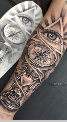 a tattoo with an eye, clock and hourglass on it's arm is shown