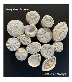 several white clay molds sitting on top of a black surface with the words clay clay ceramics