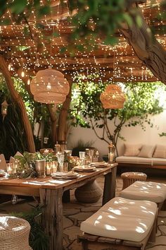 an outdoor dining area is lit up with lights