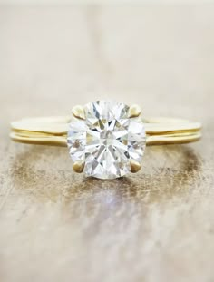 a diamond ring sitting on top of a wooden table