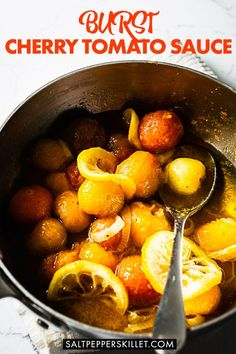 a pot filled with lemons and other food on top of a table next to a spoon