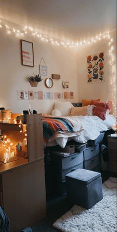 a dorm room with lights strung above the bed and storage bins on the floor