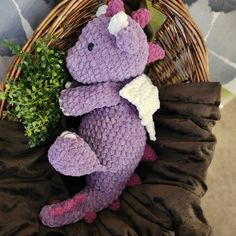 a purple crocheted stuffed animal sitting in a basket