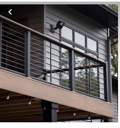 an image of a balcony with metal railings and wood balconies on the outside