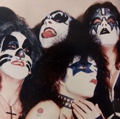 kiss band members with their faces painted black and white