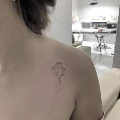 a woman with a flower tattoo on her back