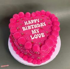 a heart shaped birthday cake with the words happy birthday my love written on it in pink frosting