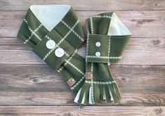 two green plaid scarves with buttons on them