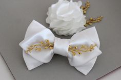 Gold Elegant Bow With Tie Back, Elegant White Bow With Butterfly Knot, Elegant White Bow Tie With Butterfly Knot, Elegant White Bow Tie For Wedding, Elegant Wedding Bow Tie, Elegant Satin Bow Tie For Wedding, Elegant Gold Wedding Bow, Elegant Gold Bow For Wedding, Elegant Wedding Bow With Ribbon