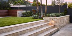 an outdoor area with grass and stone steps