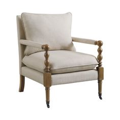 the arm chair is upholstered with wood trimmings and fabric on it