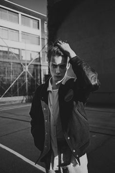 black and white photograph of a man walking down the street with headphones in his ears