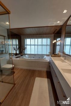 a large bathroom with two sinks and a bathtub in the middle of the room